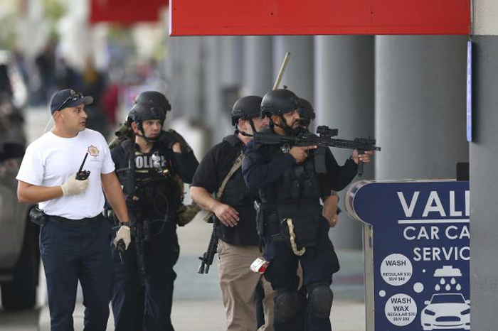 Law enforcement officers walk around Fort Lauderdale-Hollywood International Airport in Fort Lauderdale, Florida, on Friday. — AP