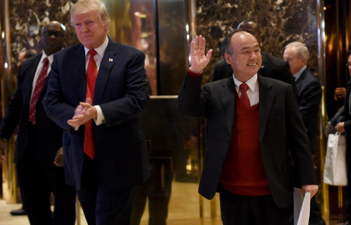 President-elect Donald Trump stands with SoftBank Group Corp. founder and Chief Executive Officer Masayoshi Son in the lobby of Trump Tower in New York. — AFP