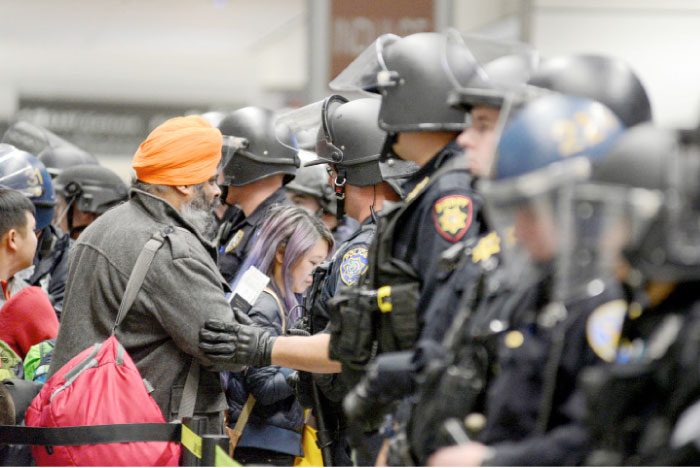 Police block a security check point as travelers try to get through for their flights inside Terminal 4 at San Francisco International Airport in San Francisco, California, Sunday. — Reuters