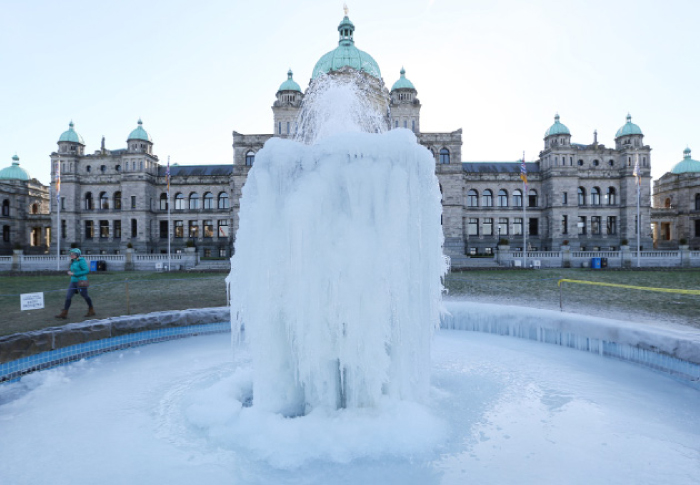 A fountain is sheathed in layers of ice during cold weather in front of the British Columbia provincial legislature building in Victoria, B.C., Canada. — Reuters