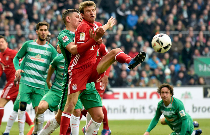 Bayern Munich's Thomas Mueller in action with Werder Bremen's Milos Veljkovic during the Bundesliga match on Saturday. — Reuters