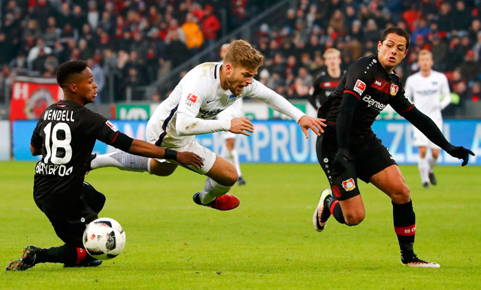 Hertha Berlin's Alexander Esswein in action with Bayer Leverkusen's Wendell and Chicharito in the Bundesliga clash.  — Reuters