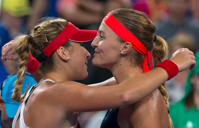 Kristina Mladenovic of France (R) is congratulated by Belinda Bencic of Switzerland at the Hopman Cup Tennis Tournament in Perth Friday. — AFP