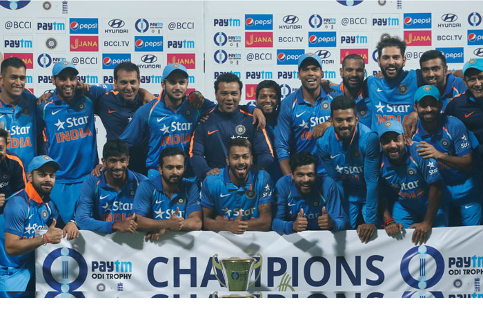 Indian team pose with trophy after winning the series after their third one day international cricket match against England at Eden Gardens in Kolkata on Sunday. India lost the match by 5 runs. — AP