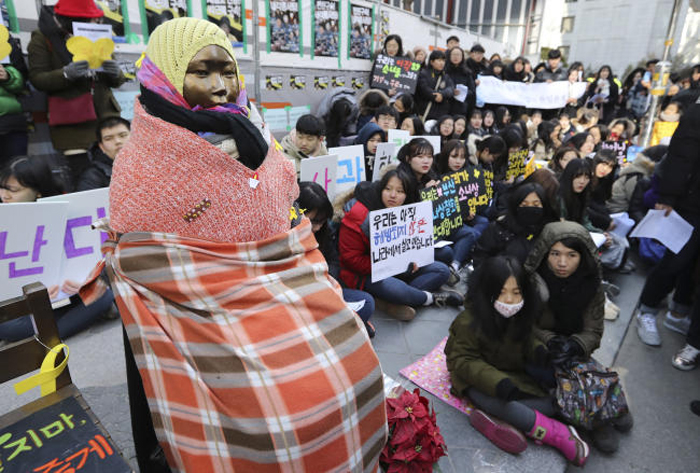 Students gather near a “comfort-woman” statue during a rally in front of the Japanese Embassy in Seoul, South Korea, on Wednesday. — AP