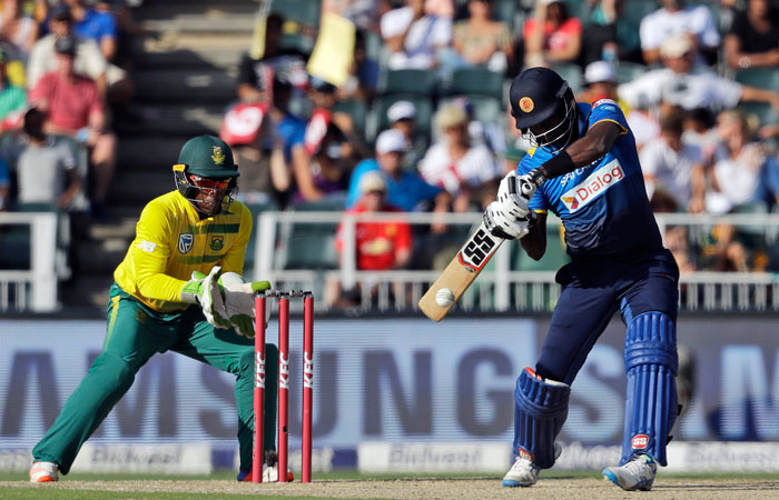 Sri Lanka's captain Angelo Mathews, right, plays a shot as South Africa's wicketkeeper Mangaliso Mosehle, watches during the T20 cricket match between South Africa and Sri Lanka, at the Wanderers stadium in Johannesburg, South Africa, on Sunday. — AP