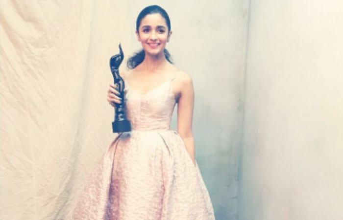 Actress Alia Bhatt poses with her Filmfare award for Best Actor (Female) backstage during the 62nd Jio Filmfare Awards in Mumbai on Saturday night.