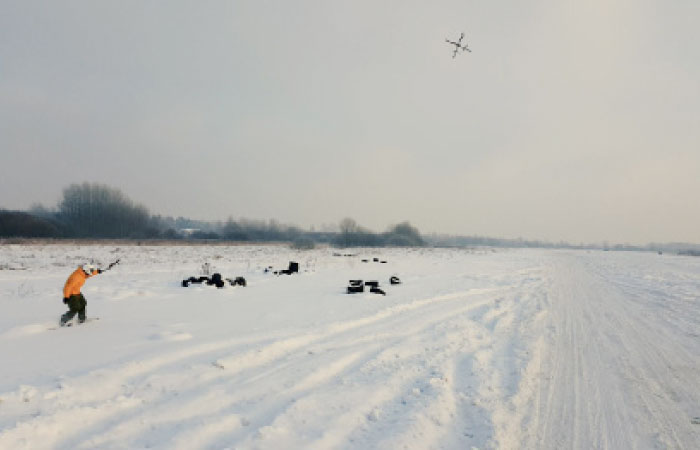 A snowboarder is pulled by an aerial drone to demonstrate “droneboarding” in Cesis, Latvia.