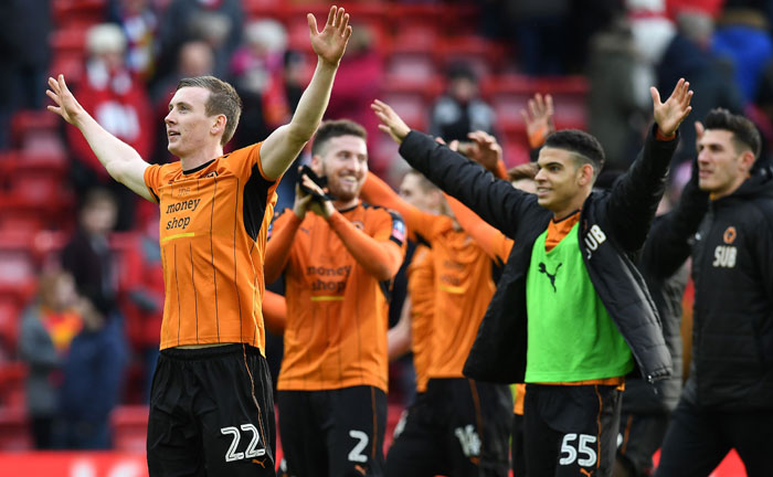 Wolverhampton Wanderers' Icelandic striker Jon Dadi Bovarsson, left, celebrates with teammates following the English FA Cup fourth round football match between Liverpool and Wolverhampton Wanderers at Anfield on Saturday. Wolverhampton won the match 2-1. — AFP