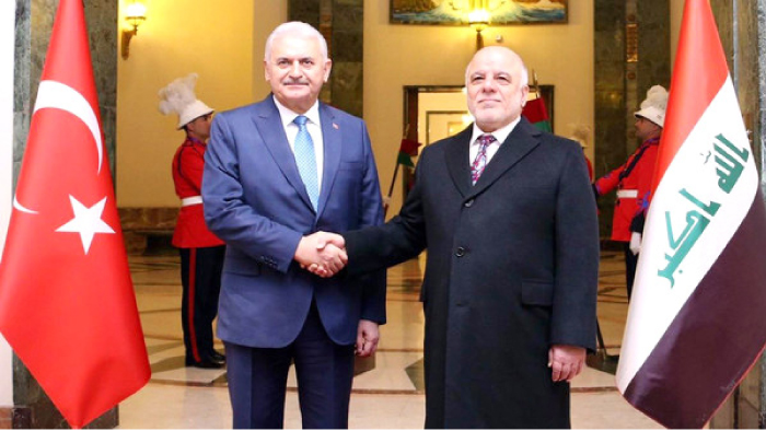 Turkish Prime Minister Binali Yildirim shakes hands with his Iraqi counterpart Haider Al-Abadi in Baghdad on Saturday.