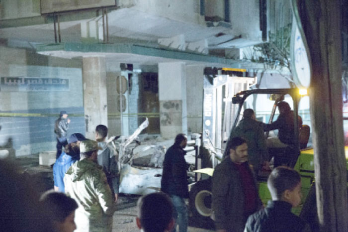 Security officers gather at the site of a car bombing near Italian Embassy in Tripoli, Libya, Saturday.  Italy’s foreign ministry said the staff at its embassy are all safe after the car bombing “in the vicinity of the Italian and Egyptian embassies” in that city. — AP