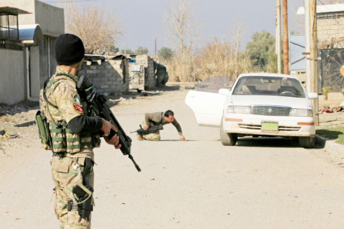 Iraqi rapid response forces inspect a car during a battle with Daesh militants in the district of Yarimja in southern Mosul. — Reuters