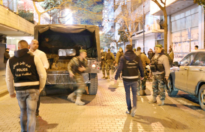 Lebanese security forces secure the street near the cafe in Hamra street in Beirut where a suicide bomber was arrested minutes before exploding himself early on Sunday. — AFP