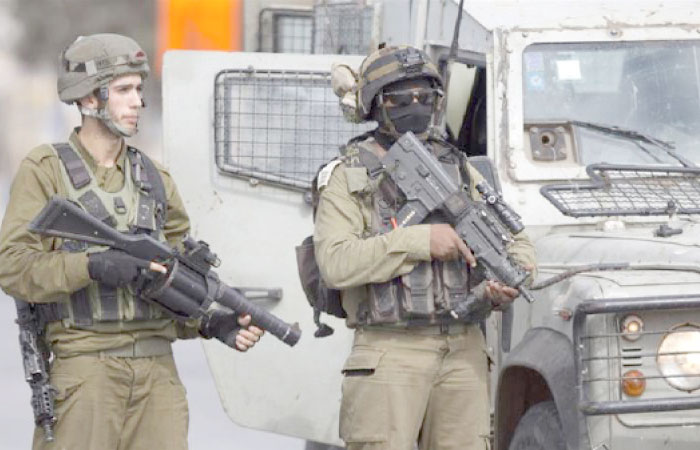 Israeli security forces stand guard at a checkpoint near Jenin. — AP file photo