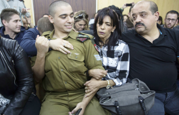 Israeli solider Sgt. Elor Azaria waits with his parents for the verdict inside the military court in Tel Aviv, Wednesday. — AP