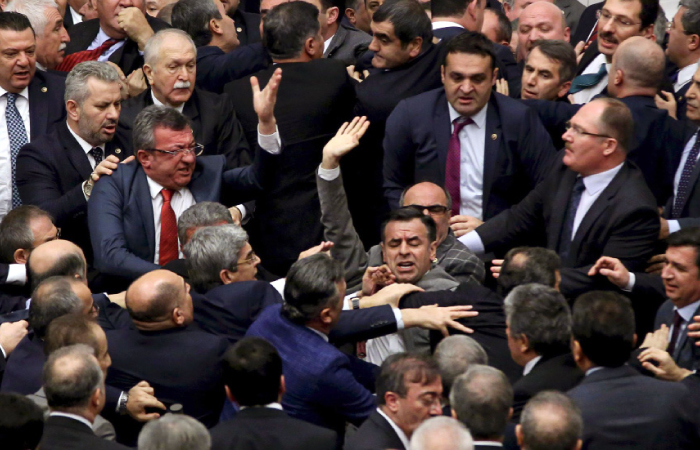 Ruling Justice and Development Party and main opposition Republican People’s Party lawmakers scuffle at the parliament in Ankara during deliberations over a controversial 18-article bill to change the constitution to create an executive presidency. — AFP