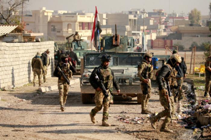 Iraqi rapid response forces gather during battle with Daesh (the so-called IS) militants in the Mithaq district of eastern Mosul, Tuesday. — Reuters