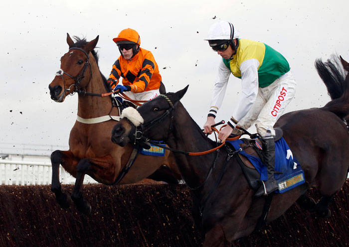 Many Clouds ridden by Leighton Aspell, right, jump an early fence in company with Thistlecrack ridden by Tom Scudamore before going on to win The Cotswold Chase Race run during Festival Trials Day at Cheltenham Racecourse, in Cheltenham, England, on Saturday. — AP