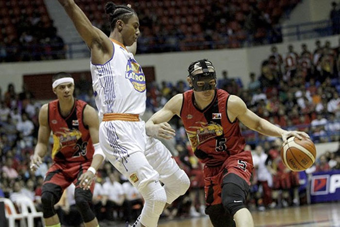 San Miguel Beer's Alex Cabagnot (5) tries to get past TNT's Matt Ganuelas-Rosser as teammate Arwind Santos (left) looks on in the PBA Philippine Cup game at the Ynares Sports Center in Antipolo City on Saturday night. — SG photo