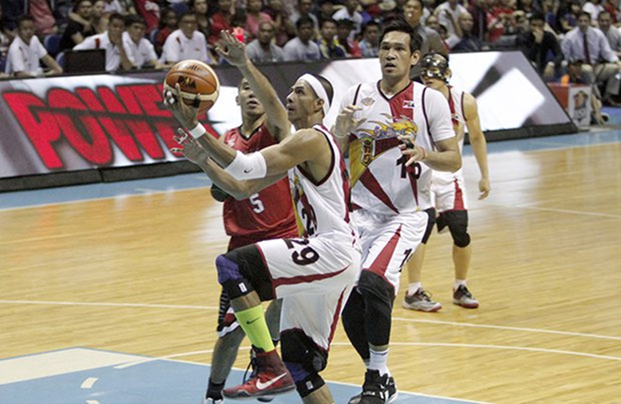 San Miguel Beer's Arwind Santos gets past Ginebra's LA Tenorio for an easy basket as June Mar Fajardo trails behind to provide support in their PBA Philippine Cup game at the Smart-Araneta Coliseum Sunday night.