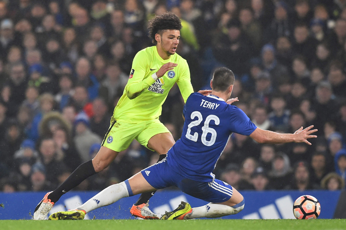 Chelsea's English defender John Terry (R) fouls Peterborough United's English striker Lee Angol to earn a red card during the English FA Cup third round match at Stamford Bridge in London Sunday. — AFP