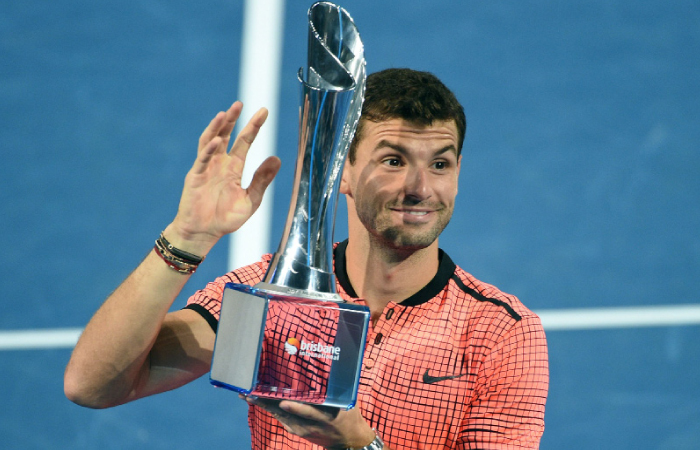 Grigor Dimitrov of Bulgaria lifts the trophy after defeating Kei Nishikori of Japan in the final at the Brisbane International Tennis Tournament Sunday. — AFP