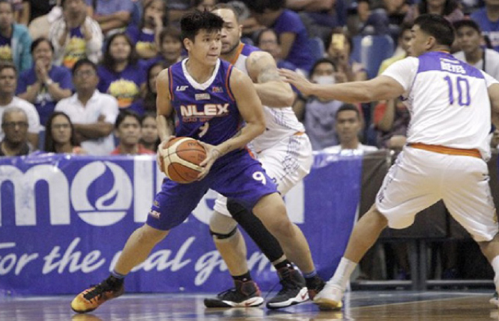 NLEX’s Carlo Lastimosa looks to pass the ball as he is double-teamed by TNT’s Kelly Williams and Ryan Reyes (R) in their PBA Philippine Cup road game in Angeles City, Pampanga, Saturday night.