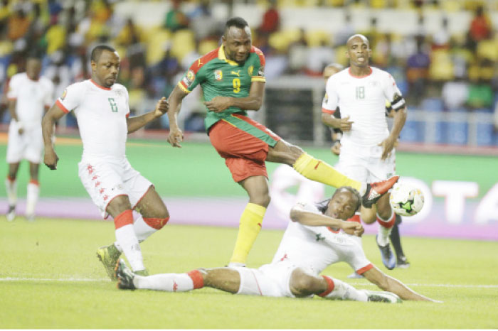 Burkina Faso’s Bakary Kone is challenged by Cameroon’s Zoua Daogari Jacques (C) during their African Cup of Nations match in Libreville, Gabon, Saturday. — AP