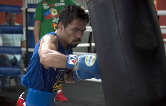 This file photo shows Philippine boxer Manny Pacquiao training at a gym in Manila. WBO welterweight world champion Manny Pacquiao is willing to square up with mixed martial arts star Conor McGregor if his potential superfight with Floyd Mayweather fails to materialize. — AFP