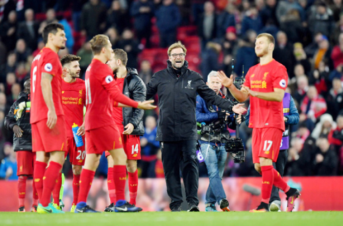 Liverpool manager Jurgen Klopp (C) celebrates with his players after beating Manchester City in the English Premier League at Anfield Saturday. — AP