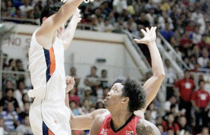 Ginebra’s Joe Devance fakes a shot, causing Meralco’s Cliff Hodge to jump high as another Meralco player defends in their PBA Philippine Cup match at the University of San Agustin Gym in Iloilo City Saturday night.