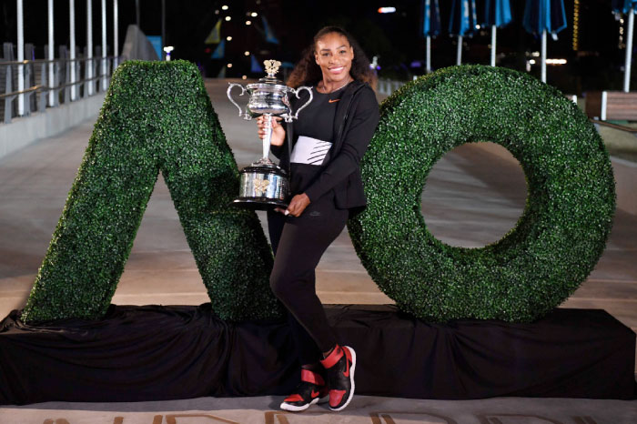 Serena Williams of the US poses with the championship trophy after her victory against Venus Williams of the US in the women’s singles final on day 13 of the Australian Open tennis tournament in Melbourne on Saturday. — AFP