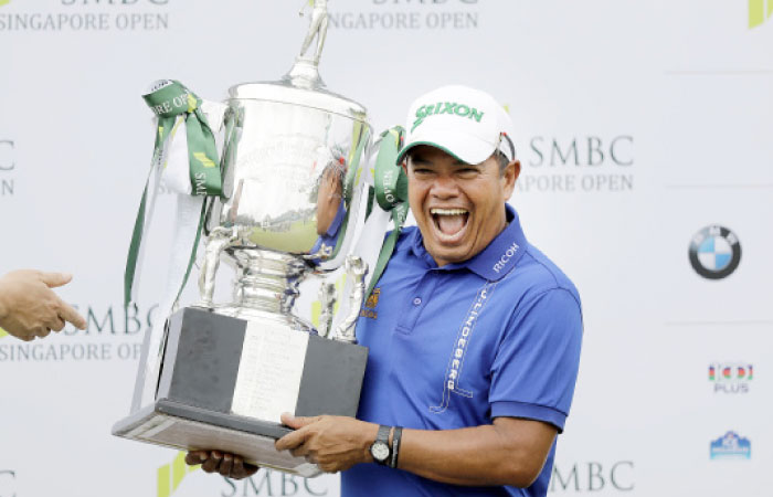 Prayed Marksaeng of Thailand smiles as he lifts his trophy after winning the SMBC Singapore Open golf tournament at Sentosa Golf Club’s Serapong Course on Sunday, in Singapore. — AP