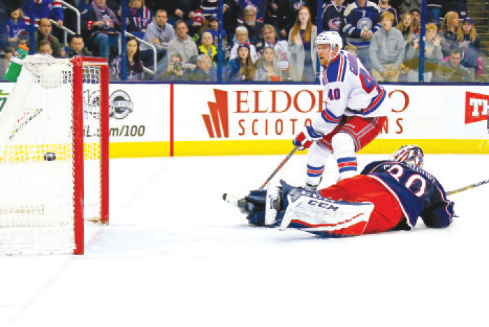 Michael Grabner (No. 40) of the New York Rangers beats Curtis McElhinney of the Columbus Blue Jackets for the game-winning goal during their NHL game at Nationwide Arena in Columbus Saturday. — AFP