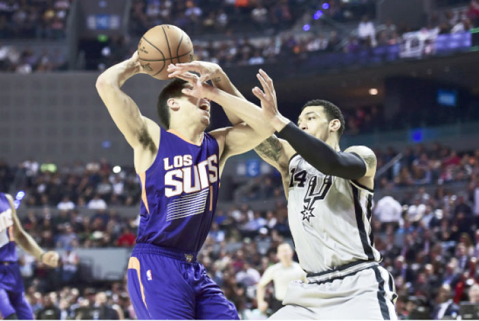 Phoenix Suns’ Devin Booker (L) vies for the ball with San Antonio Spurs’ Dany Green (R) during their NBA Global Games match at the Mexico City Arena in Mexico City Saturday. — AFP