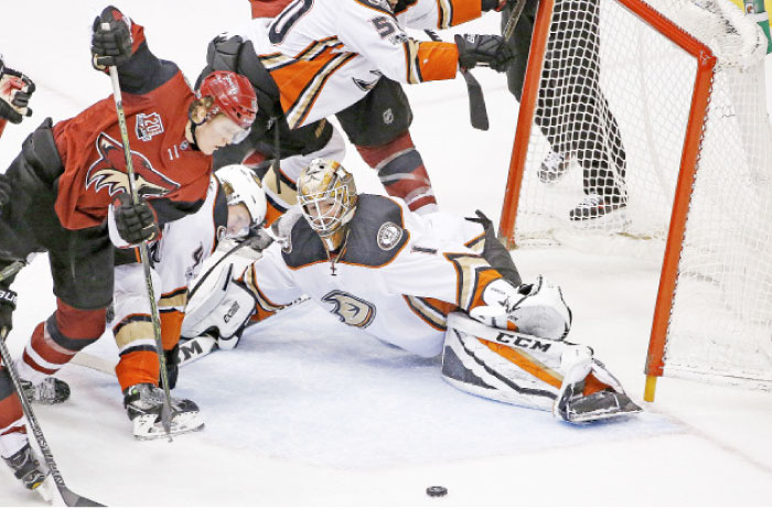 Arizona Coyotes’ center Christian Dvorak (L) tries to get to the puck as Anaheim Ducks’ goalie Jonathan Bernier (No. 1) slides over to make the save while Ducks’ defenseman Hampus Lindholm (2nd L) defends during the third period in Glendale, Arizona, Saturday. – AP