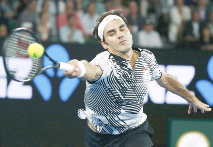 Switzerland’s Roger Federer hits a shot during his men’s singles semifinal match against Switzerland’s Stan Wawrinka in Melbourne THursday. - Reuters