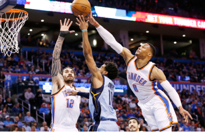 Oklahoma City Thunder’s Russell Westbrook (R) blocks a shot by Memphis Grizzlies’ Mike Conley during their NBA game in Oklahoma City Wednesday. — AP