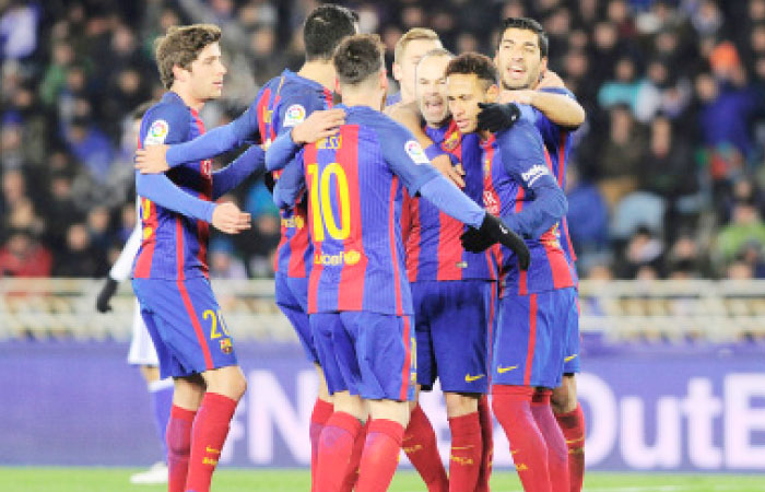 Barcelona’s players celebrate after Brazilian forward Neymar scored his team’s first goal during their Spanish Copa del Rey (King’s Cup) quarterfinal first-leg match against Real Sociedad in San Sebastian Thursday. - AFP