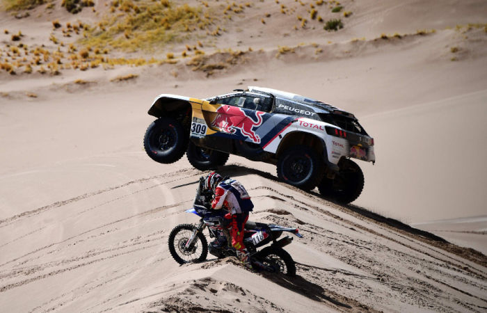Peugeot’s French driver Sebastien Loeb and co-driver Daniel Elena of Monaco and Yamaha’s Japanese biker Shinnosuke Kazama compete during Stage 4 of the 2017 Dakar Rally between San Salvador de Jujuy in Argentina and Tupiza in Bolivia Thursday. - AFP