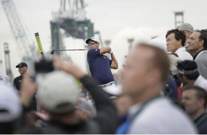 Adam Scott of Australia tees off on the 7th hole during the SMBC Singapore Open golf tournament at Sentosa Friday. - AP