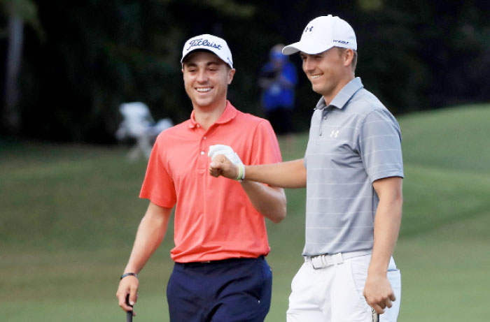 Justin Thomas of the United States is congratulated by Jordan Spieth of the United States after chipping in on the tenth hole during the first round of the Sony Open In Hawaii Thursday. - AFP