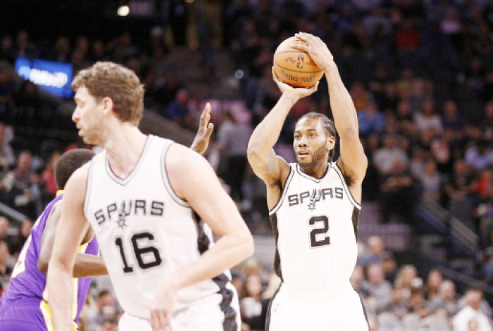 San Antonio Spurs’ forward Kawhi Leonard shoots over Los Angeles Lakers’ forward Luol Deng during their NBA game at AT&T Center in San Antonio Thursday. — Reuters