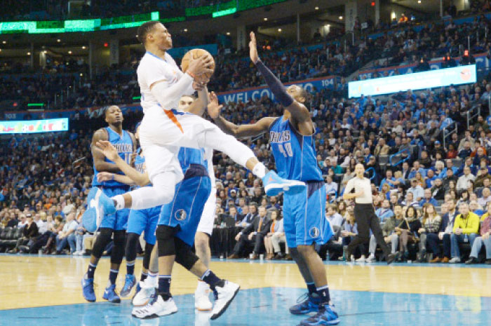 Oklahoma City Thunder guard Russell Westbrook drives to the basket in front of Dallas Mavericks forward Harrison Barnes (No. 40) during the fourth quarter at Chesapeake Energy Arena Thursday. - Reuters