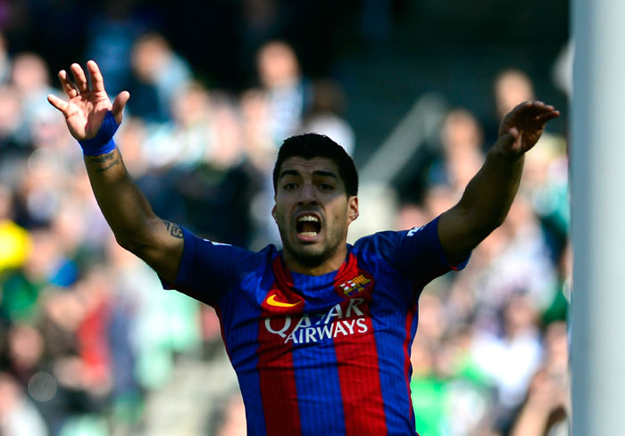 Barcelona's Uruguayan forward Luis Suarez (C) gestures during the Spanish league football match against Real Betis at the Benito Villamarin stadium in Sevilla on Sunday. The match ended in a draw 1-1. — AFP