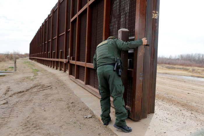 A US Border patrol agent opens a gate on the fence along the Mexico border to allow vehicles pass in El Paso, US, in this Jan.17, 2017 file photo. — Reuters