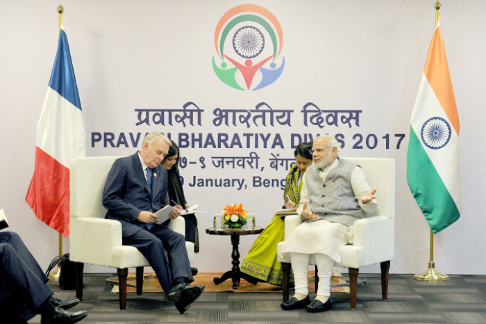 French Minister of Foreign, Affairs and International Development Jean-Marc Ayrault, left, speaks with Indian Prime Minister Narendra Modi at the Pravasi Bharatiya Divas 2017 event in Bangalore on Sunday. — AFP