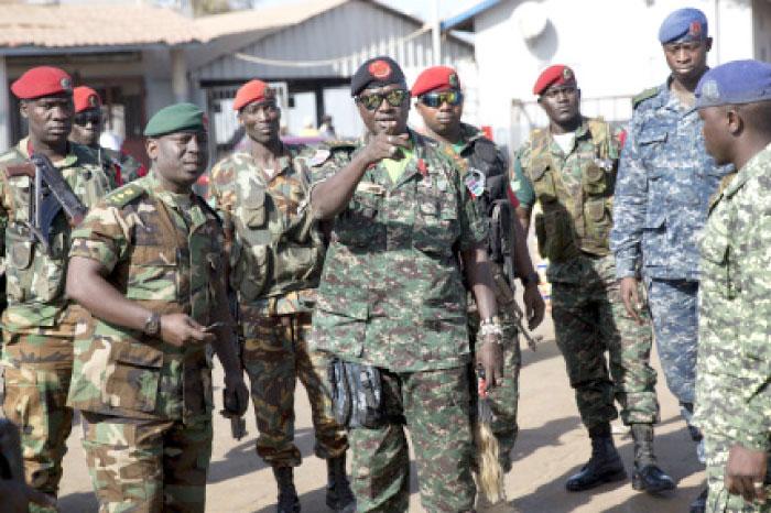 Gambian Armed Forces Chief Ousmane Bargie, center, arrives at the ferry terminal in Banjul, Gambia, on Sunday. — AP