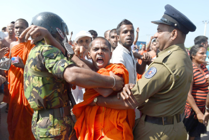 Sri Lankan security personnel and Buddhist monks clash during a protest in the southern port city of Hambantota, Sri Lanka, on Saturday. — AFP