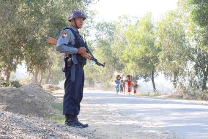 An armed Myanmar police officer is posted on the road during the arrival of the UN special rapporteur on Myanmar in Buthidaung to visit areas of northern Rakhine State on Saturday. — AFP